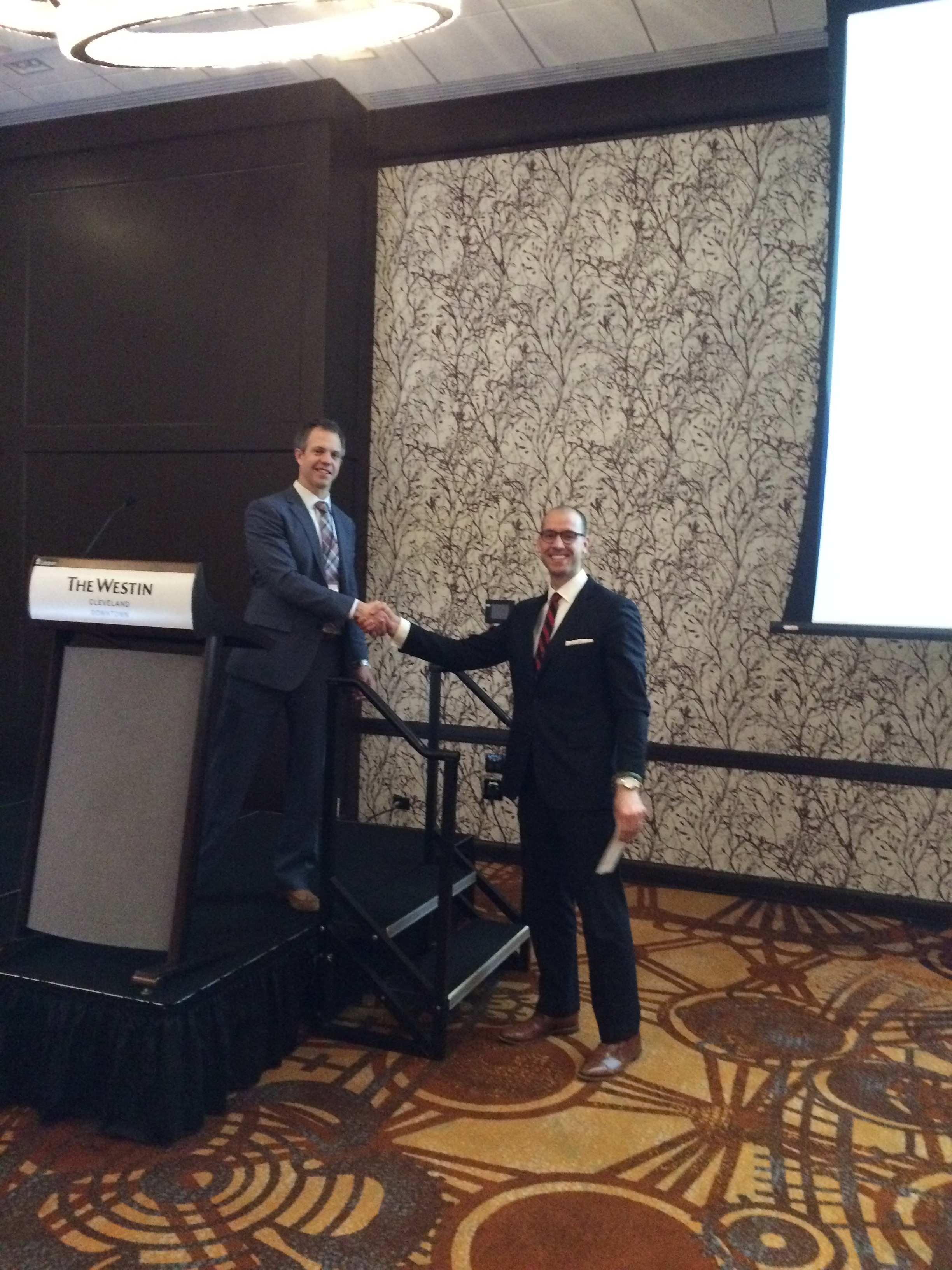 Dr. Geoffrey Box congratulating an award recipients